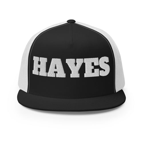 A flat-brim snapback cap embroidered with the golfer's name