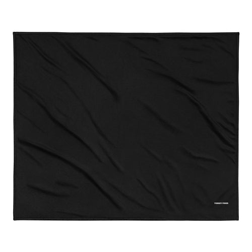 A thick woven blanket with the golfer's name and course embroidered in the corner