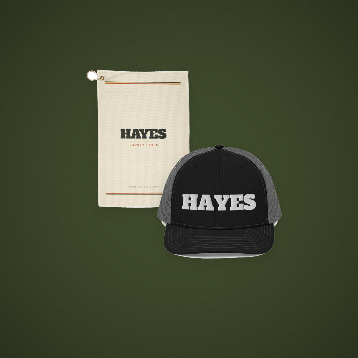 A personalized golf towel and an embroidered trucker hat on a deep green ground