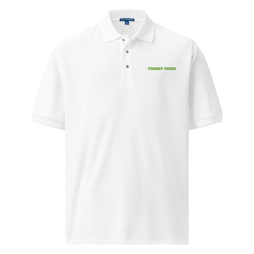 The Embroidered Polo, a white piqué golf polo with a name embroidered on the left chest in kiwi green thread